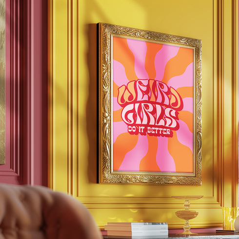 Retro-style poster with psychedelic 1970s-inspired design. Text reads "WEIRD GIRLS DO IT BETTER" in wavy, groovy lettering. Pink and orange sunburst background. Centered text surrounded by curved rays. Bold red frame with scalloped edges. Vibrant colors and playful typography create a vintage hippie vibe. Square format print with rounded corners. Perfect for fans of retro aesthetics and empowering slogans.